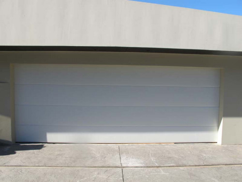 Flush solid garage door